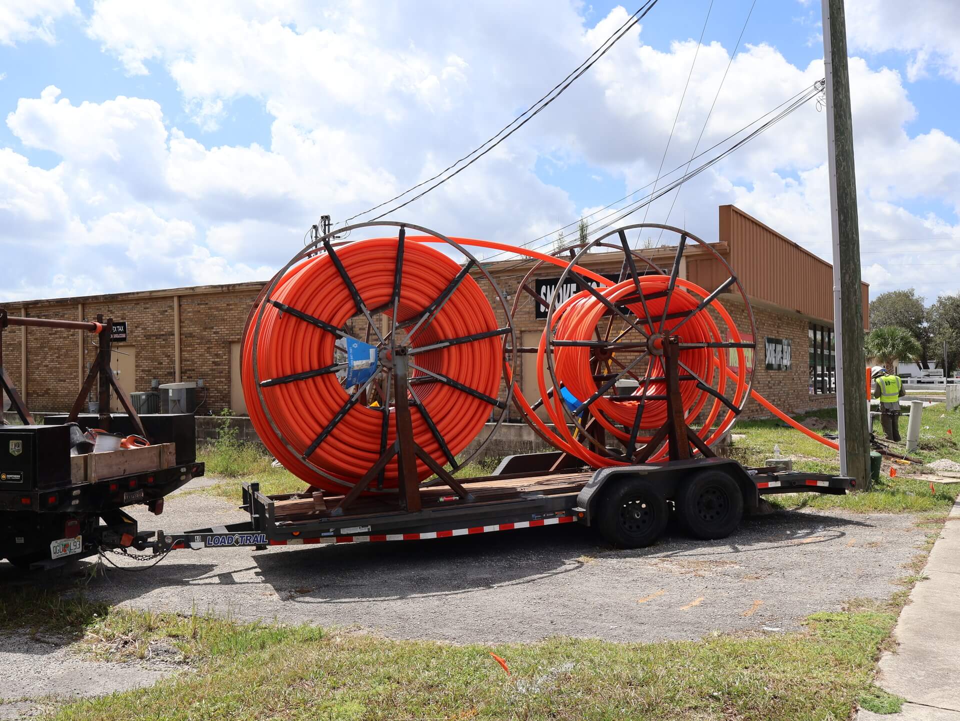 HDPE conduit reels staged on a trailer at a Superior Technologies job site in Florida